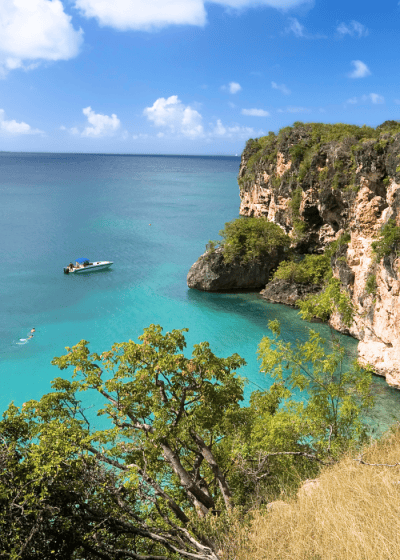 Serene coastal view with turquoise waters and boat.