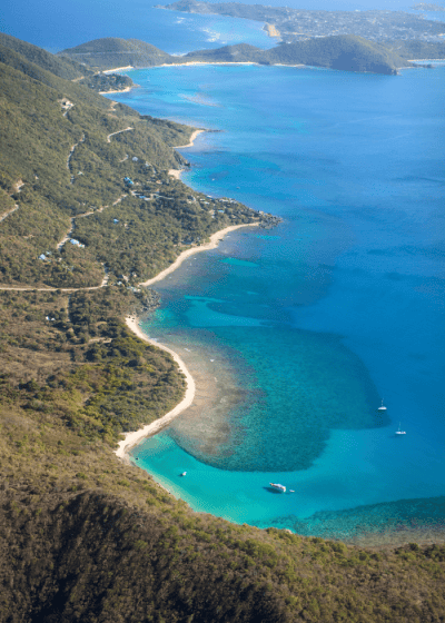 Aerial view of a tropical coastline and boats.