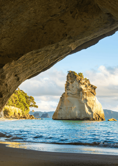 Rock formation viewed through a cave entrance.