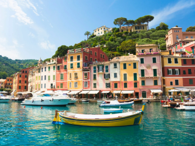 Colorful seaside village with boats and clear water.