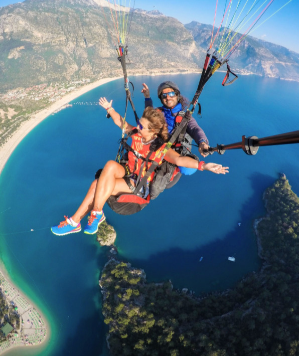 Paragliding over a scenic coastal landscape.