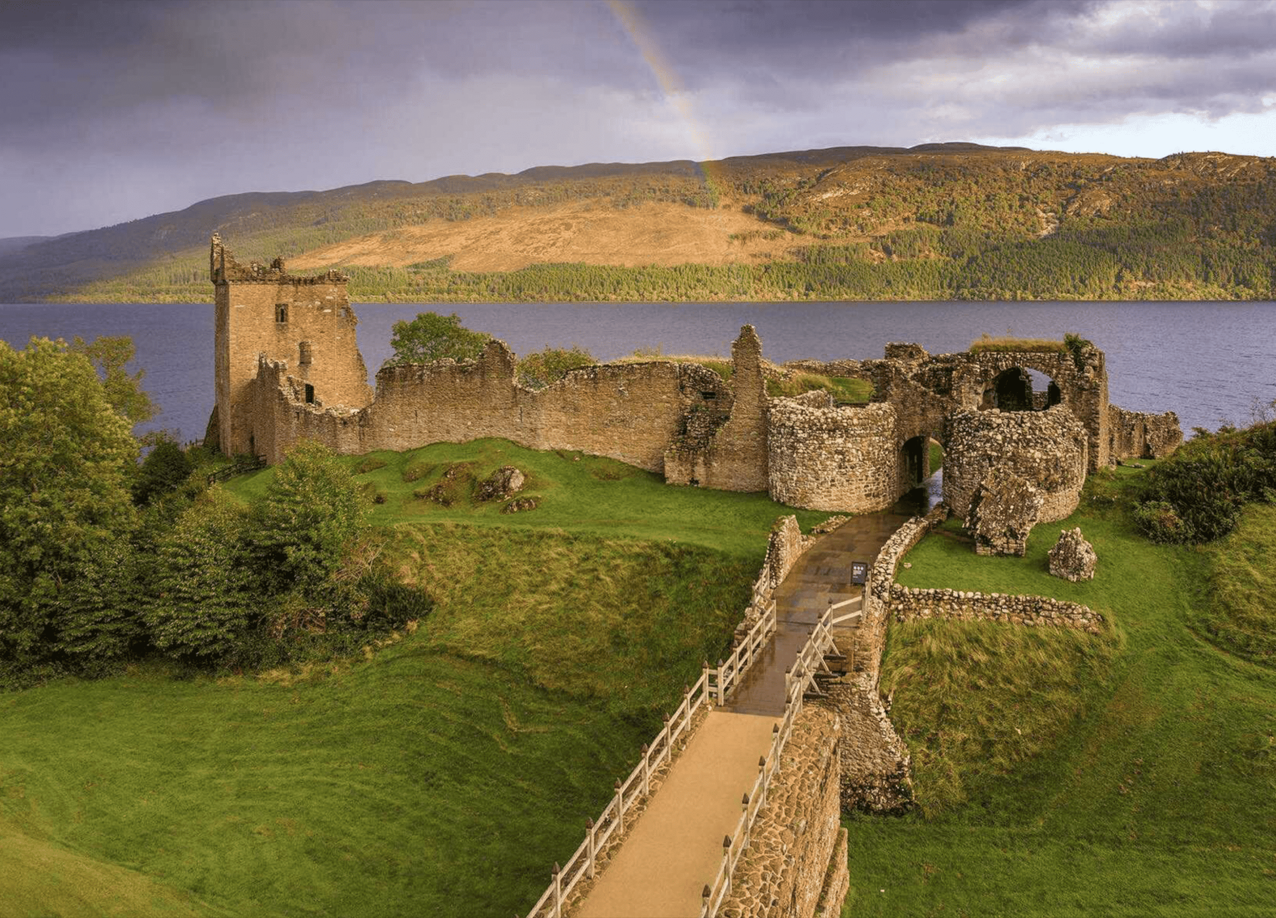 Urquhart Castle ruins with rainbow over Loch Ness