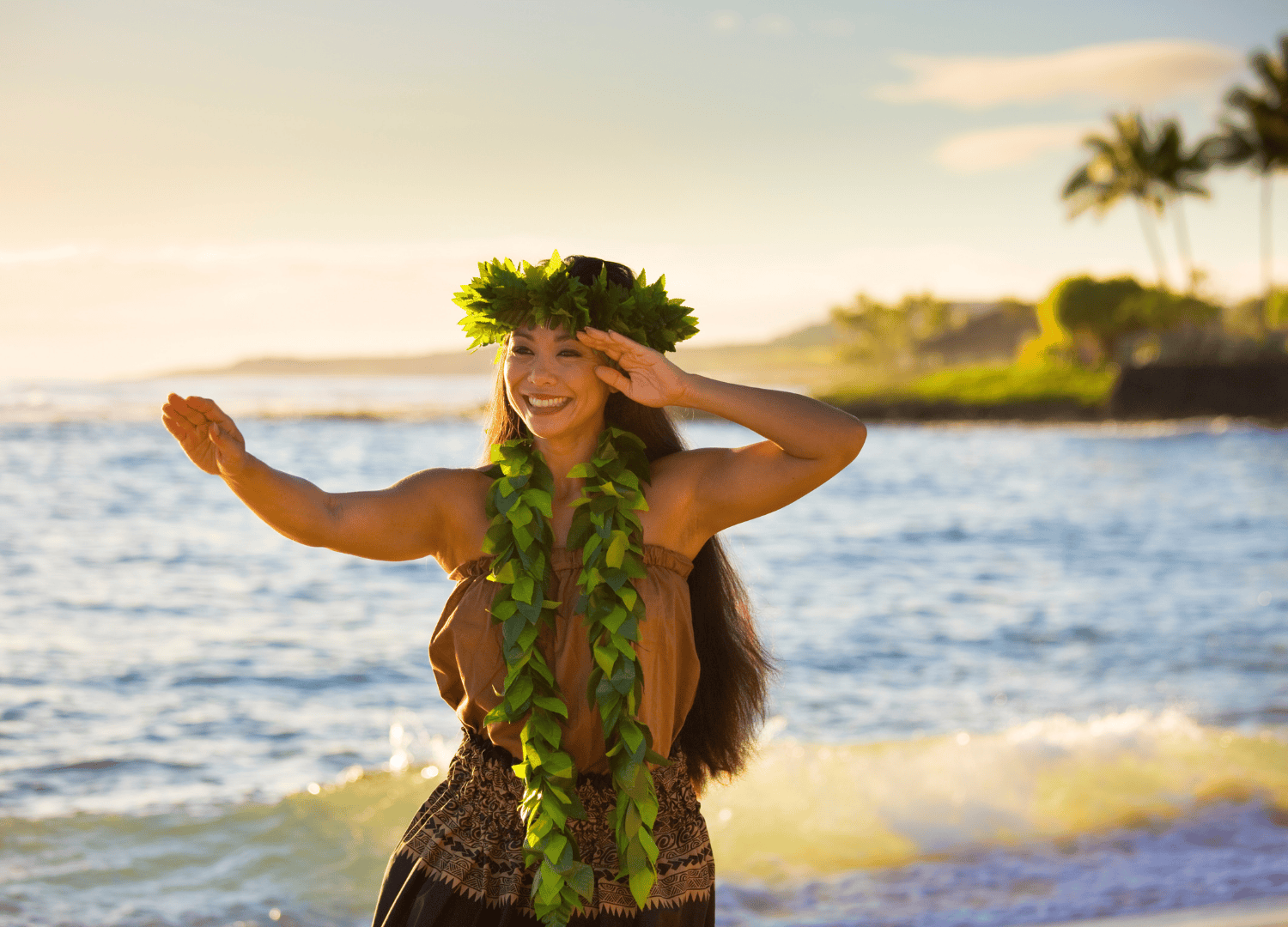 Hula dancer performing by the ocean.