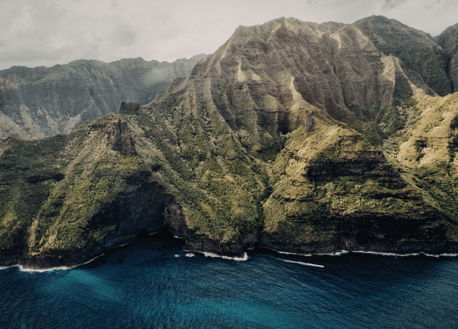 Aerial view of lush green mountainous coastline.