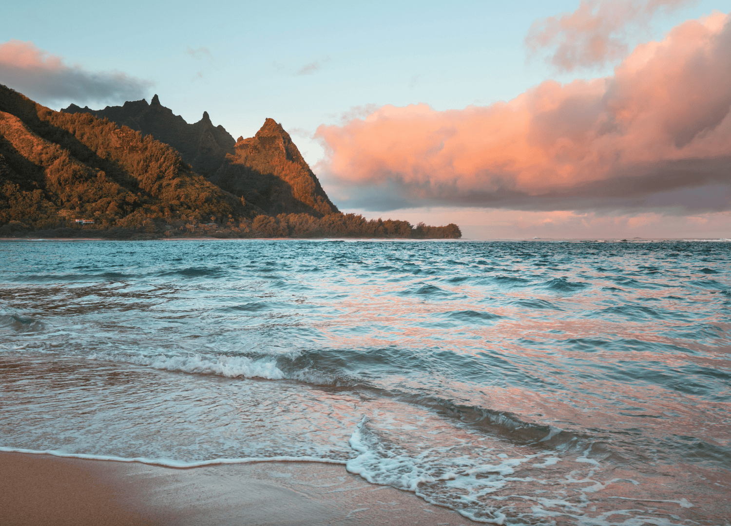 Scenic ocean view with lush green mountains.