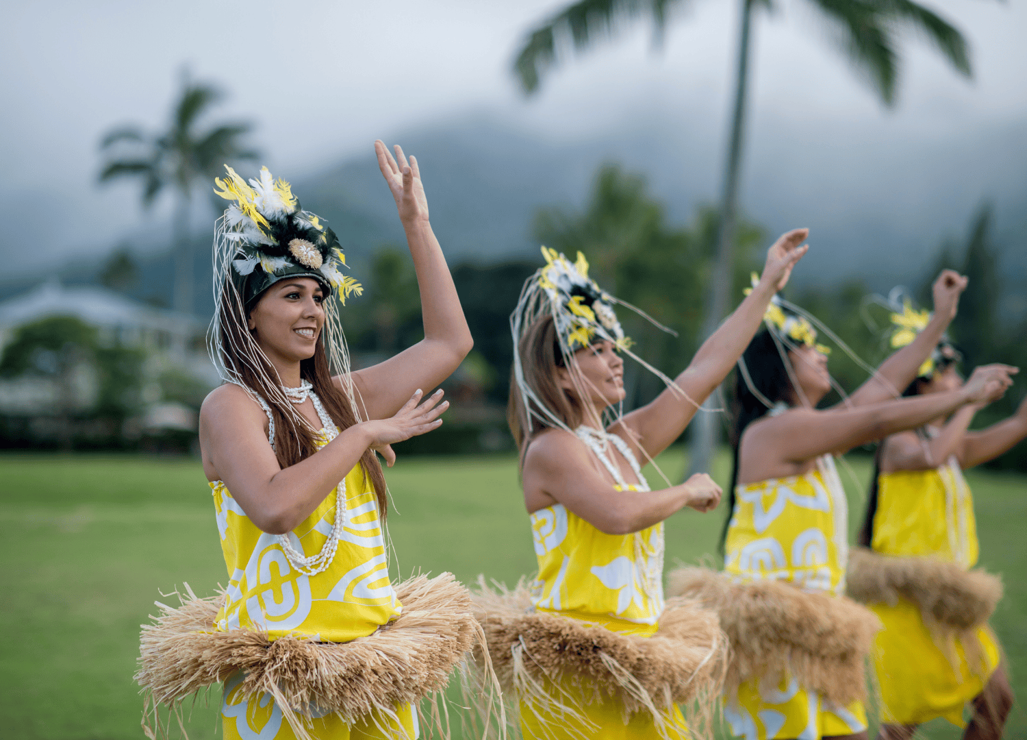 Women performing traditional Polynesian dance in vibrant attire.