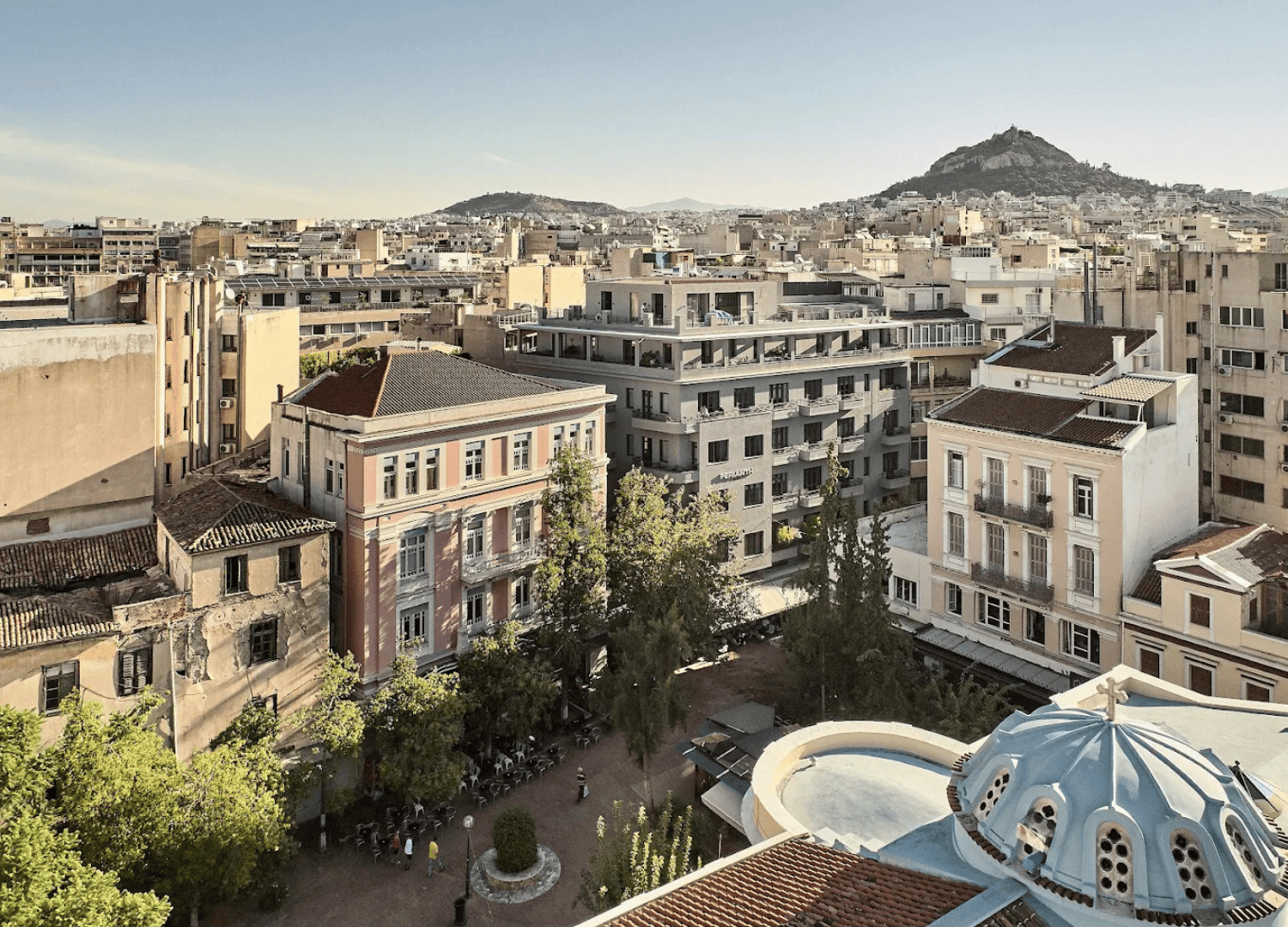 Athens cityscape with Lycabettus Hill in background.