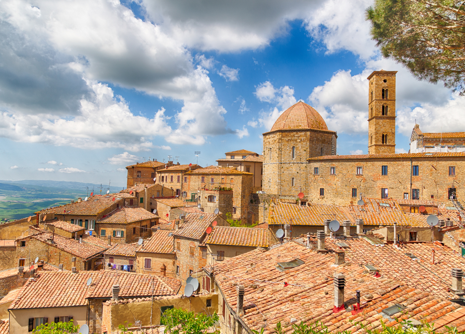 Historic Volterra skyline with medieval architecture and sky.