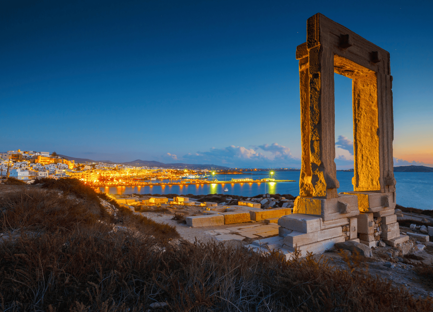 Portara at sunset overlooking Naxos harbor