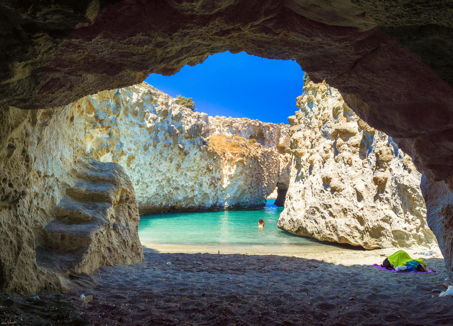 Cave view of turquoise water and cliffs