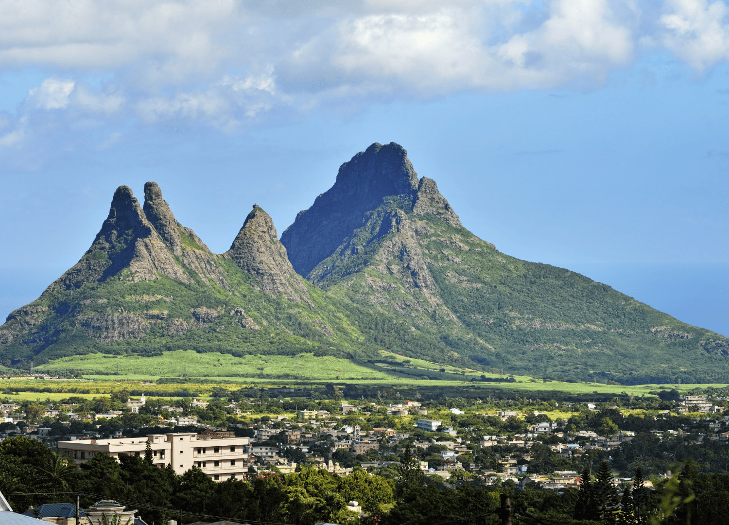 Majestic mountain peaks above city landscape.