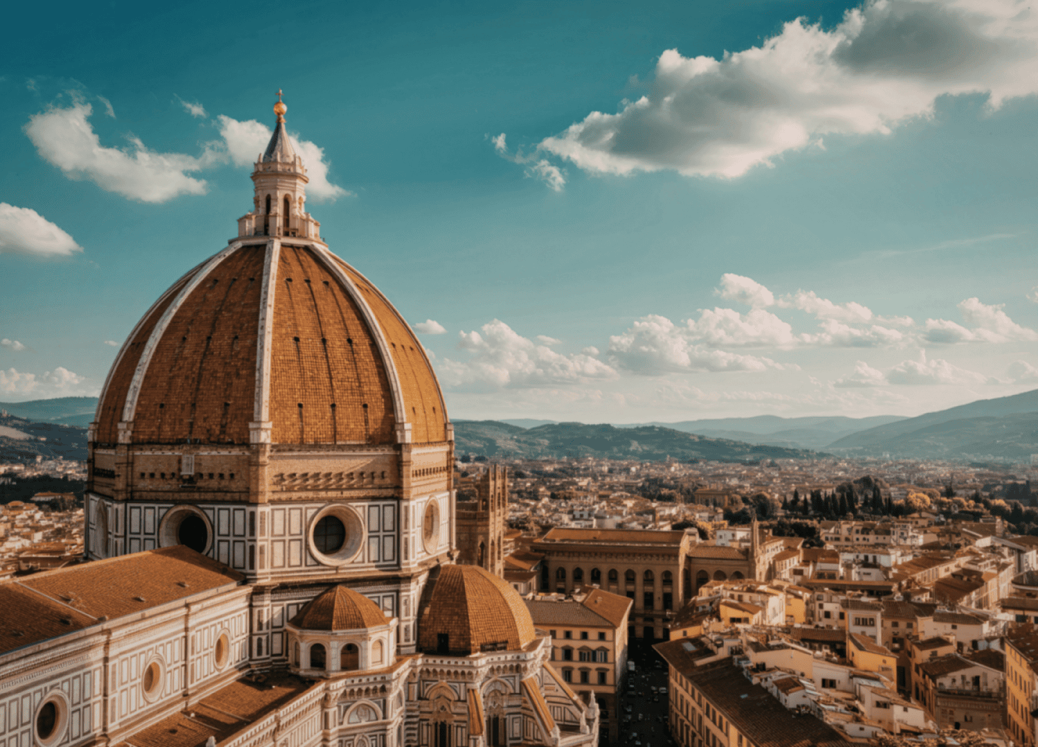 Florence cathedral dome against blue sky with clouds.