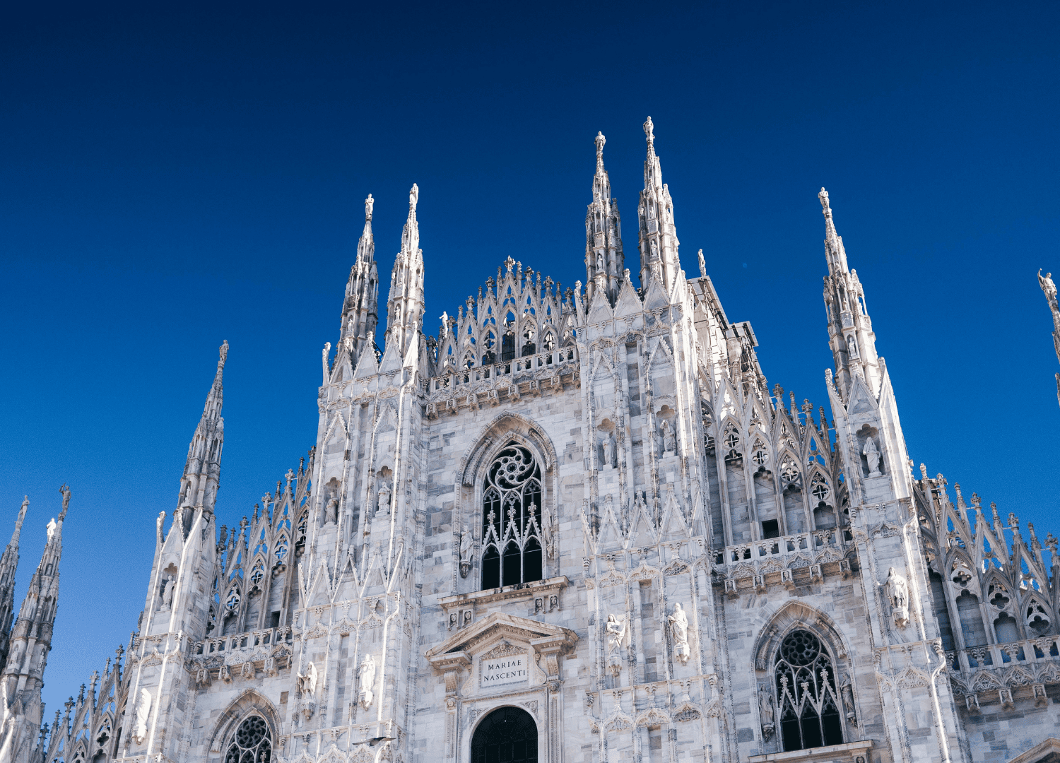 Gothic cathedral under clear blue sky.